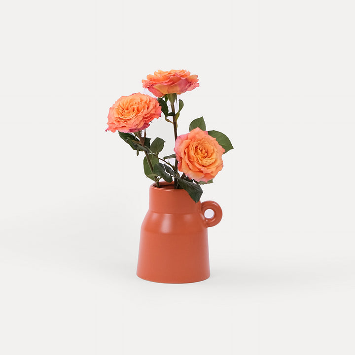 Roses Orange in Clay Vase Arrangement