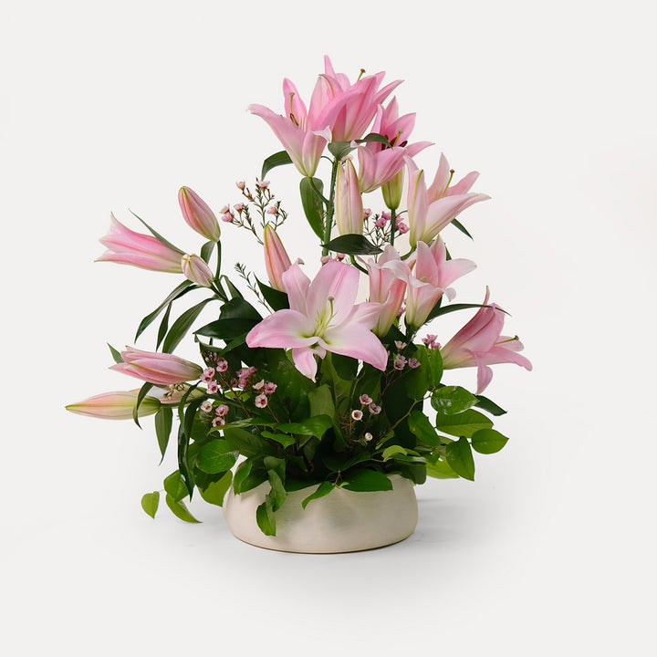 Pink lily Flower arrangement in ceramic vase