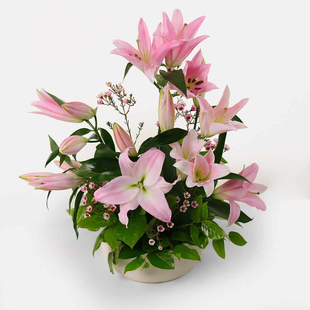 Pink lily Flower arrangement in ceramic vase