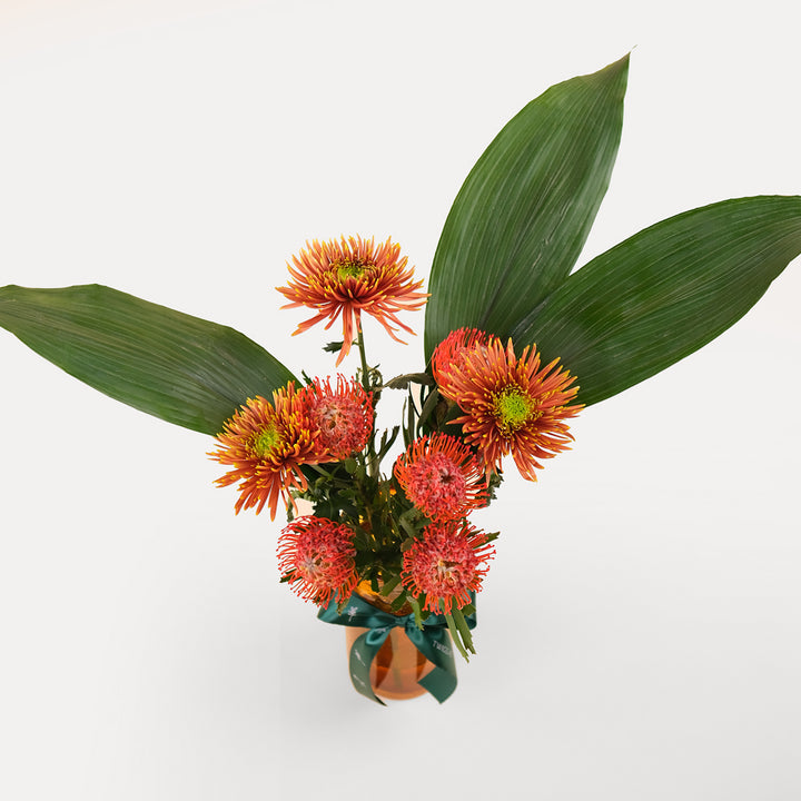 TROPICAL LEUCOSPERMUM ORANGE FLOWER VASE ARRANGEMENT