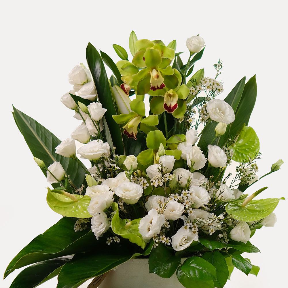 special orchids with lily and lisianthus flower arrangement in white ceramic vase