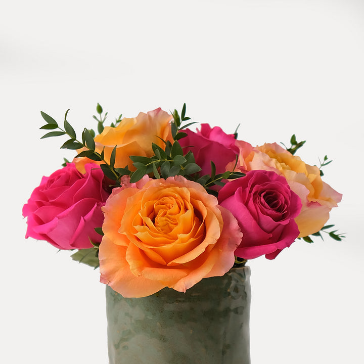 Diwali vibrant flower arrangements in green ceramic vase