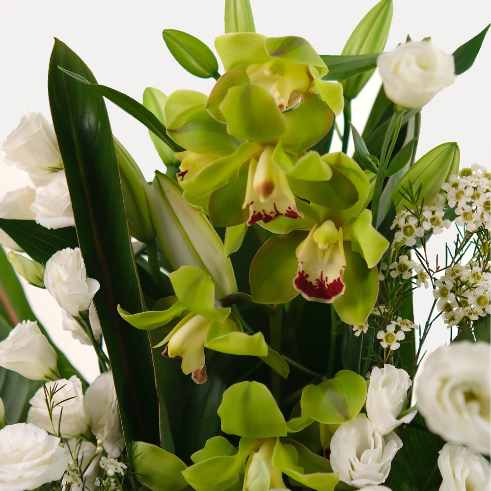 special orchids with lily and lisianthus flower arrangement in white ceramic vase