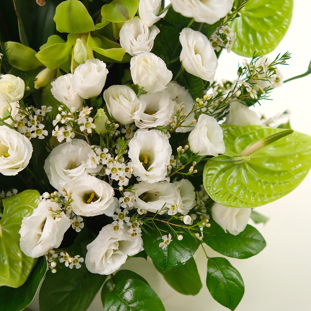 special orchids with lily and lisianthus flower arrangement in white ceramic vase