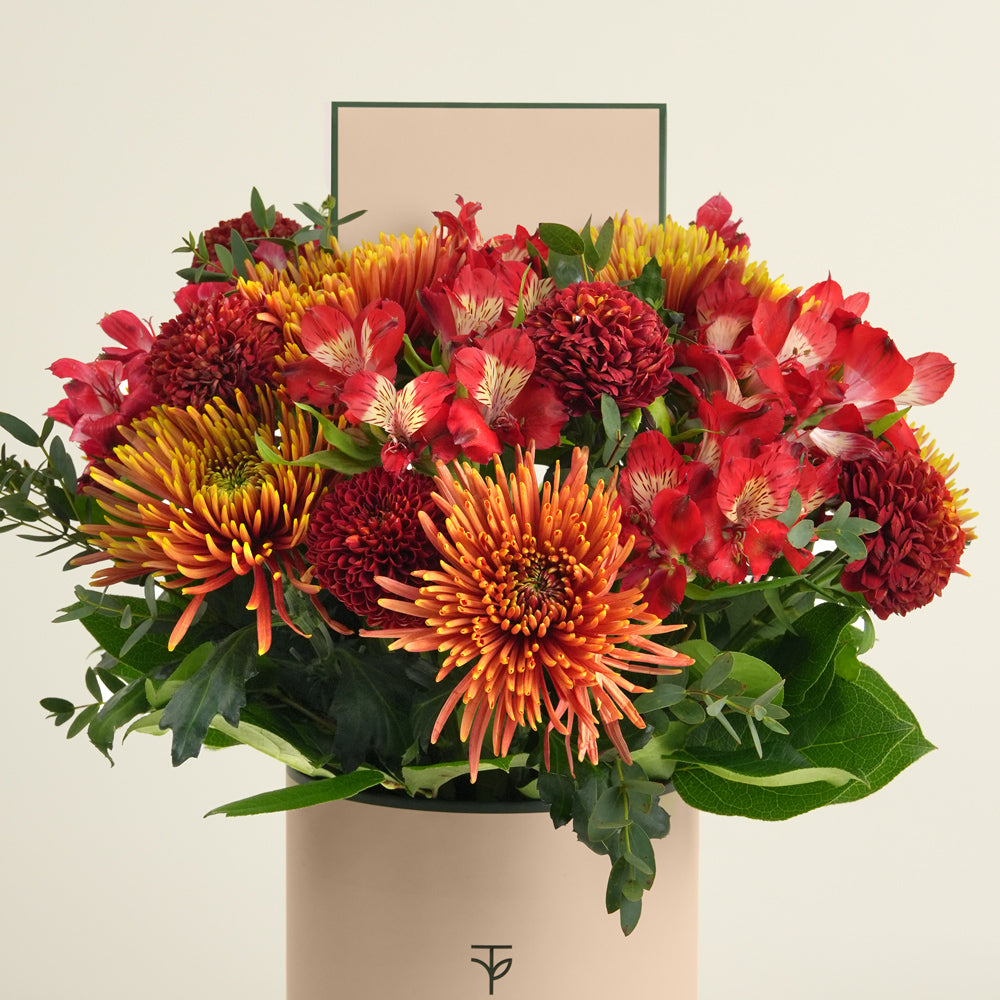 Eid flower arrangement with saffina chrysanthemums, burgundy ping pong chrysanthemums and red alstroemerias in TWIGS deluxe round box Dubai