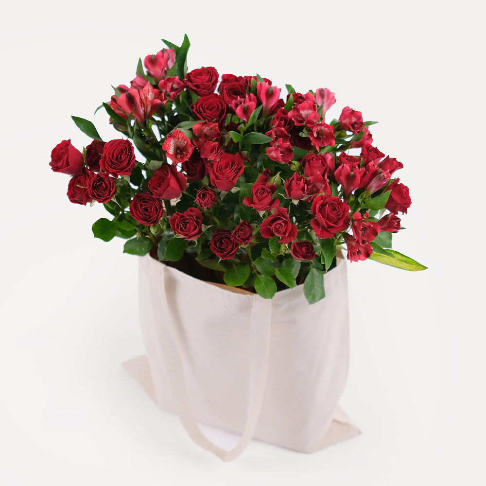 Red Spray Roses & Red Alstroemerias in a Reusable Canvas Tote – A Passionate Blend for Memorable Moments