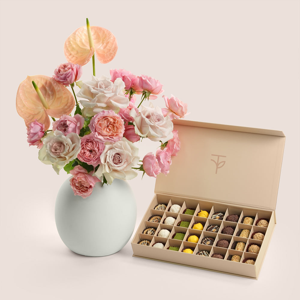 Blush roses and peach anthurium in TWIGS ceramic vase with 32-piece truffle box — Eid Al Adha luxury gift set Dubai
