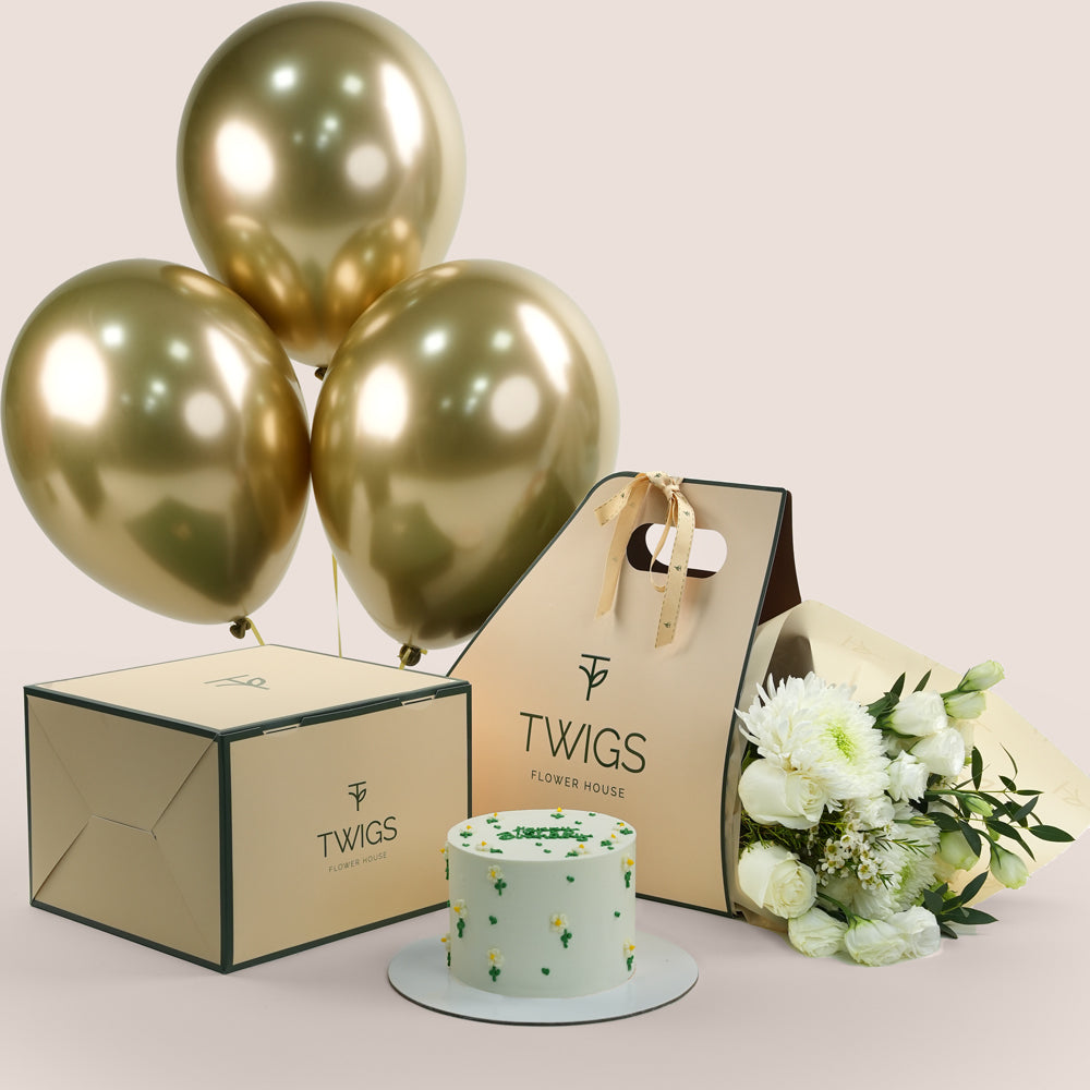 Gold balloons, birthday  cake, and flowers 