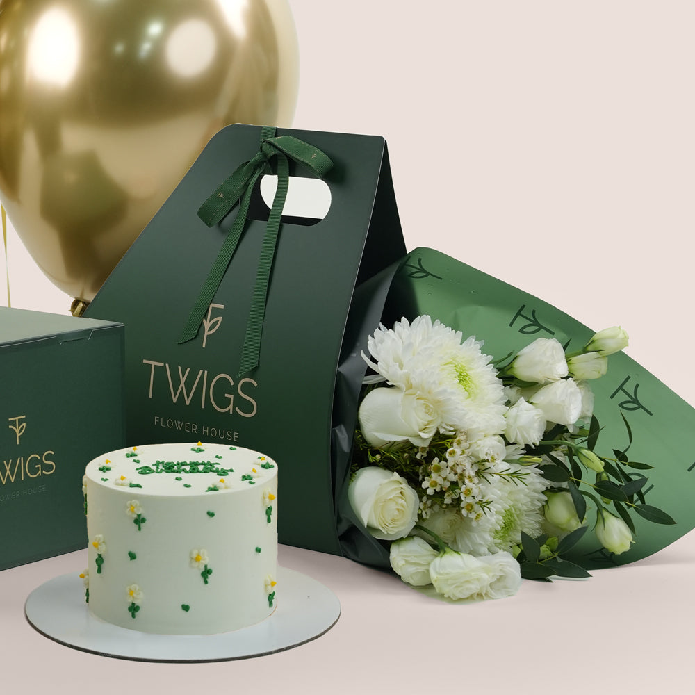 Gold balloons, birthday  cake, and flowers 