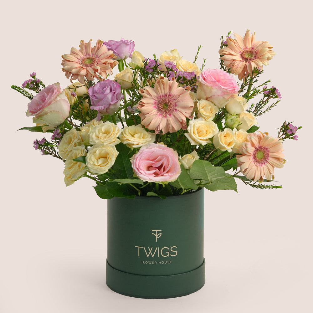 Birthday Floral arrangement in a green box with 'TWIGS' branding on a light background