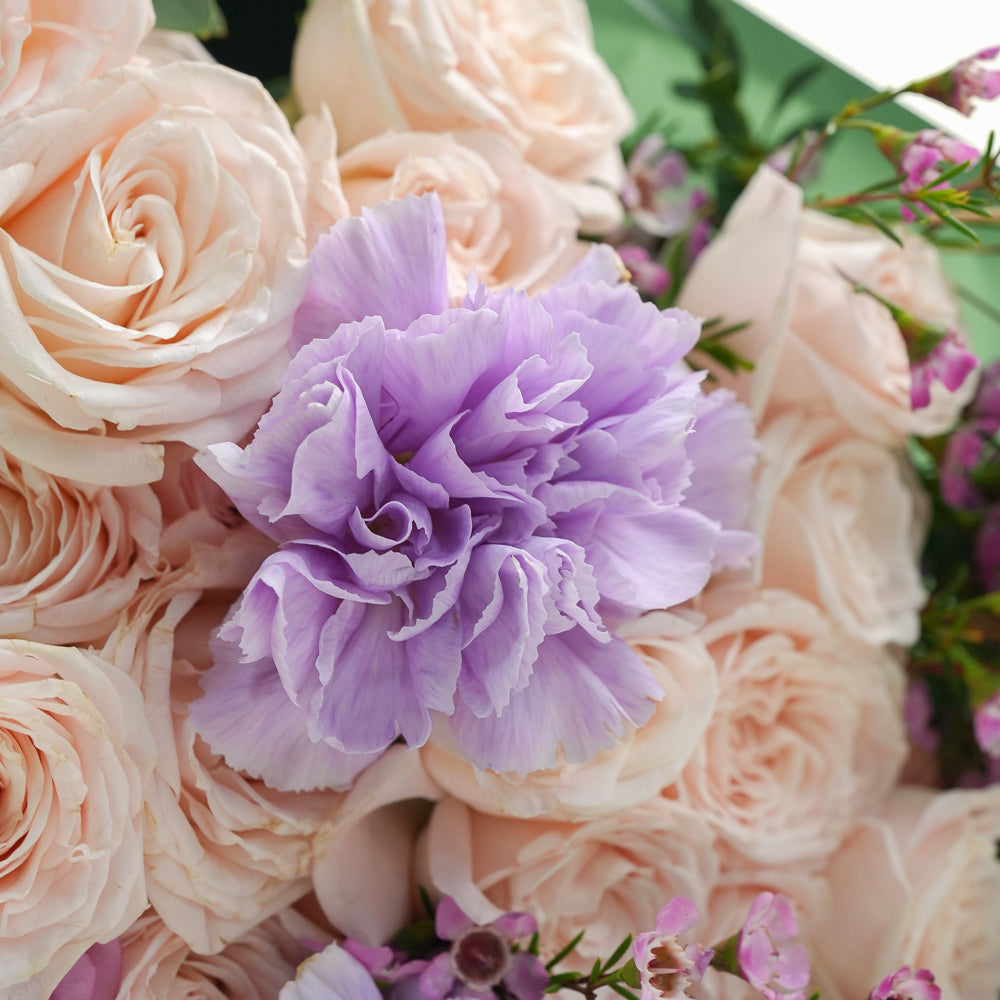 Birthday cake and bouquet of flowers with purple balloons