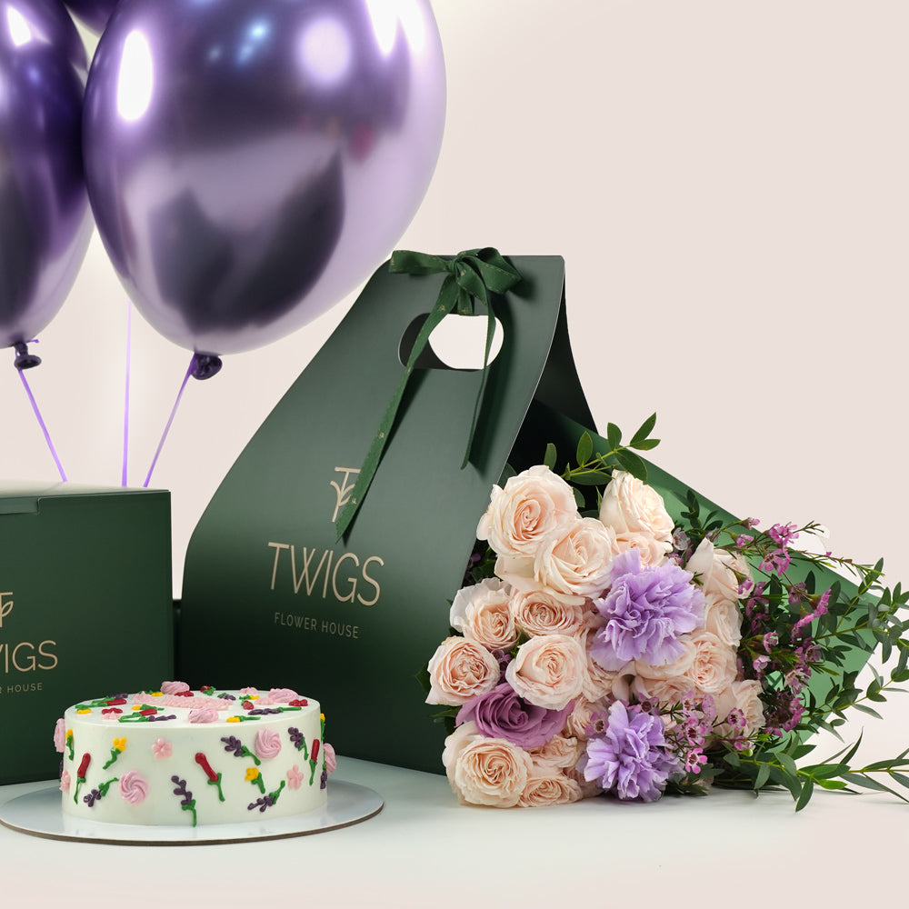 Birthday cake and bouquet of flowers with purple balloons