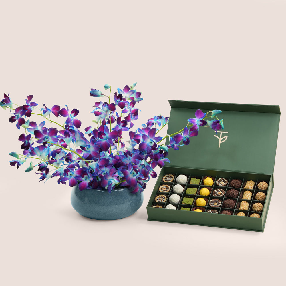 Blue dendrobium orchid ceramic vase with 32-piece truffle and petite fours box — Eid Al Adha luxury gift set Dubai