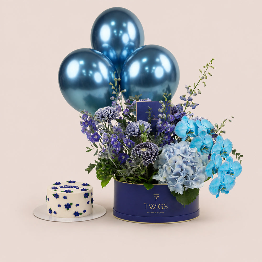 Blue Hour Birthday Bundle - navy round box with blue delphiniums, hydrangeas and orchids, matching floral birthday cake, and blue chrome balloons - TWIGS Flower House Dubai