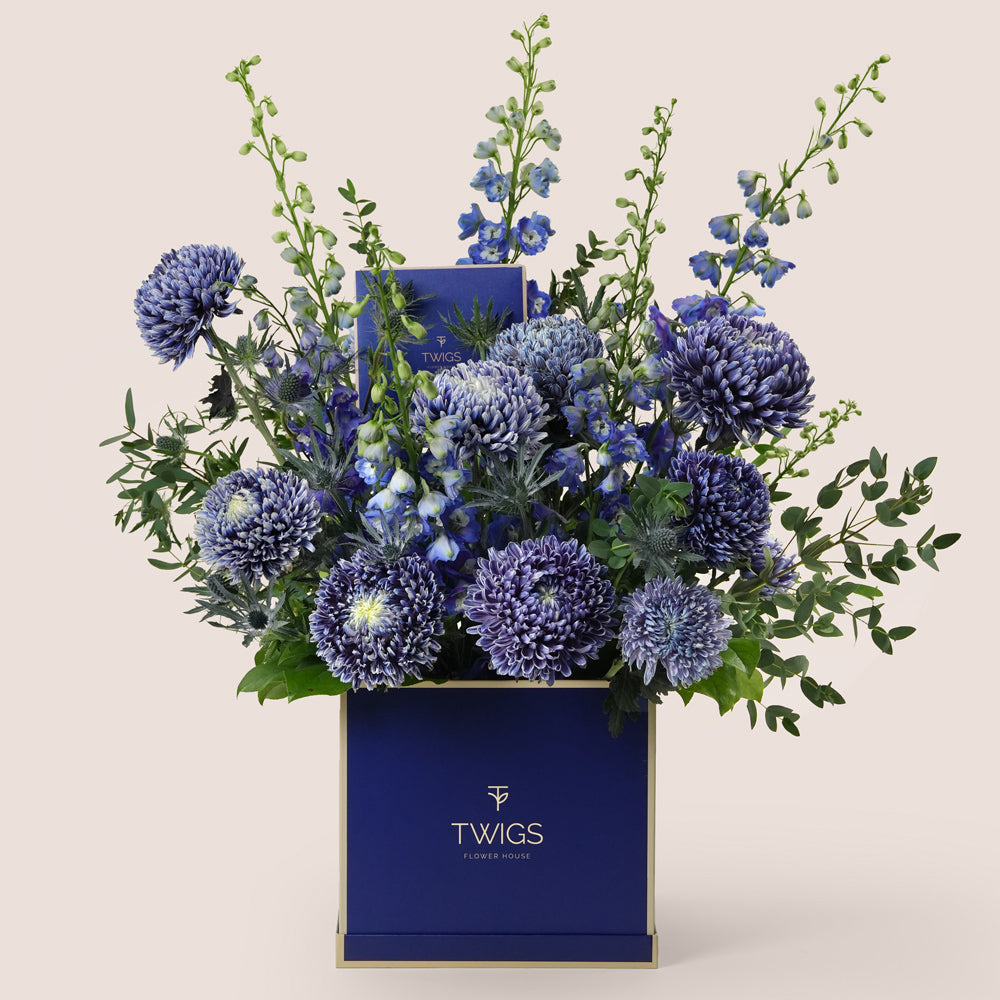 Indigo — blue delphiniums, chrysanthemums and eryngiums in a TWIGS navy square box, Father's Day blue flower arrangement Dubai