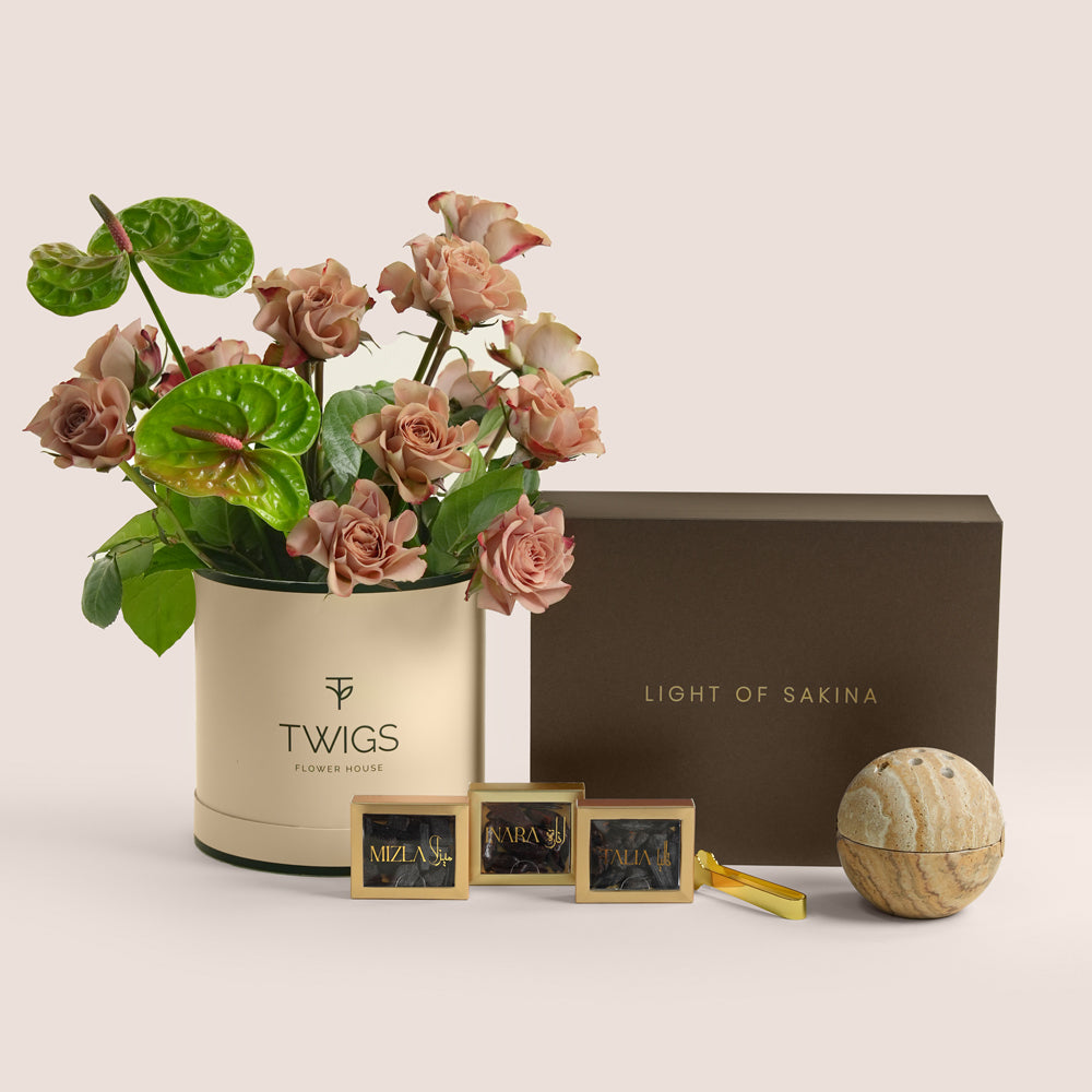 Café latte roses and green anthurium beside a TUBA Jelani bakhoor set with stone mabkhara and gold tongs, TWIGS x Light of Sakina collaboration
