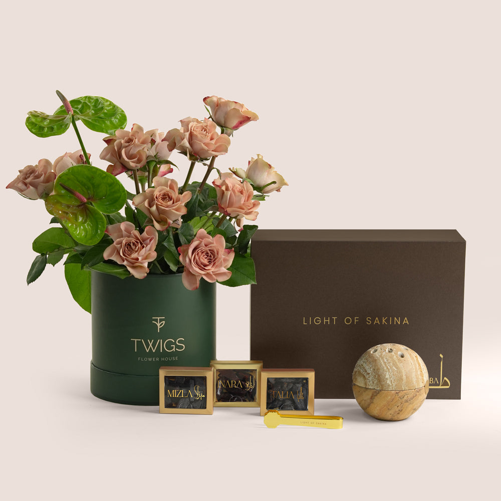Café latte roses and green anthurium beside a TUBA Jelani bakhoor set with stone mabkhara and gold tongs, TWIGS x Light of Sakina collaboration