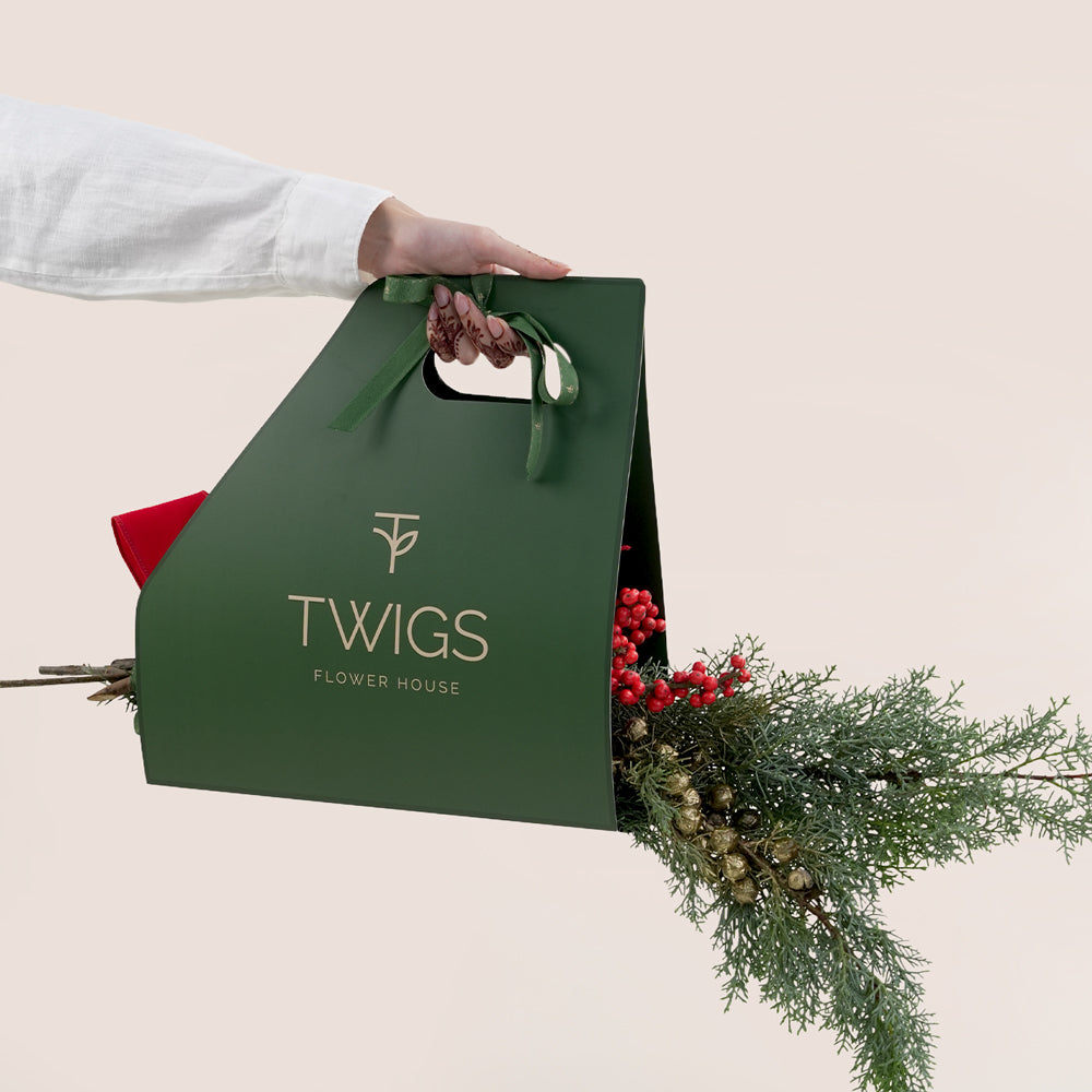Green 'TWIGS' flower house bag with christmas wreath arrangement 
