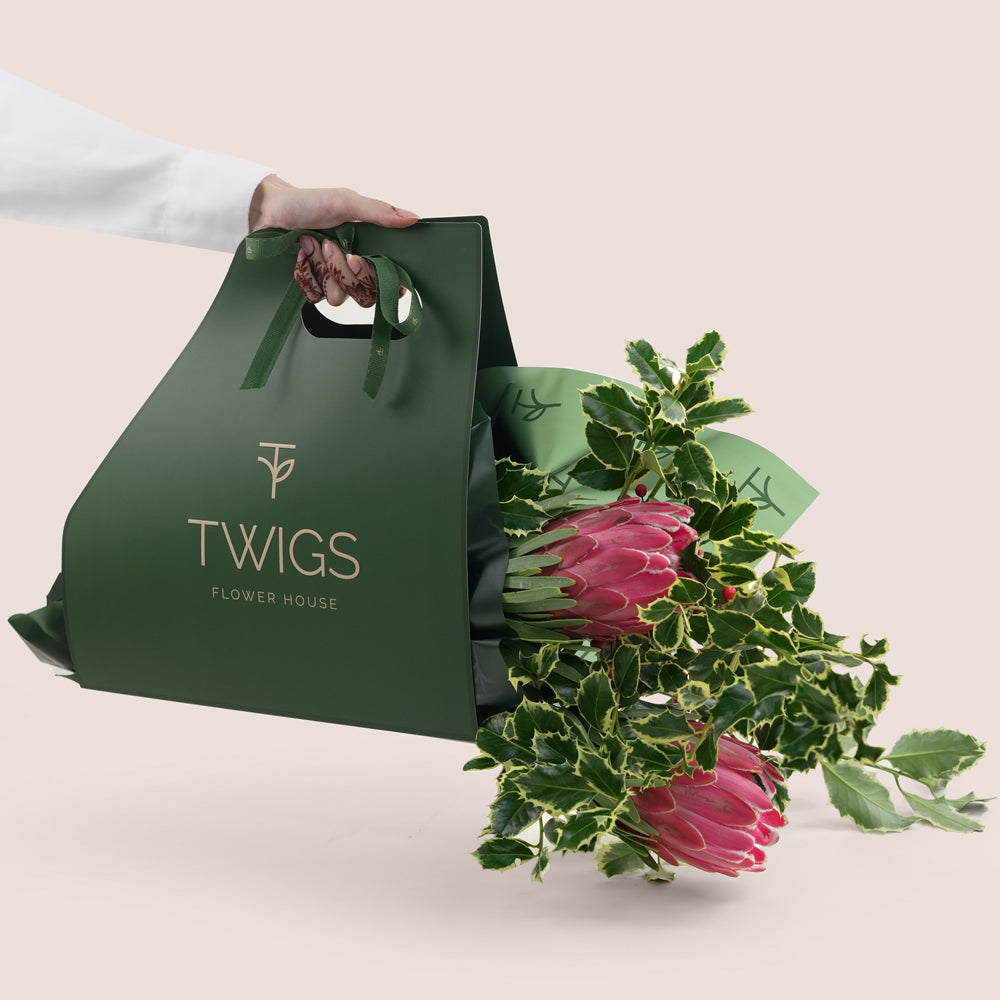 Green Twigs Flower House bag with a bouquet of flowers on a light background