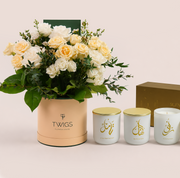  Cream and white roses with Salinero in a TWIGS box beside three Scent of Medina candles, TWIGS x Light of Sakina collaboration