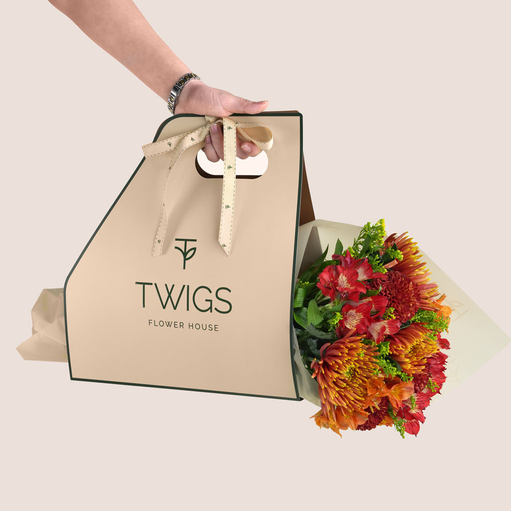 Eid flower bunch with saffina chrysanthemums, burgundy ping pong chrysanthemums and red alstroemerias in TWIGS green carry pack Dubai