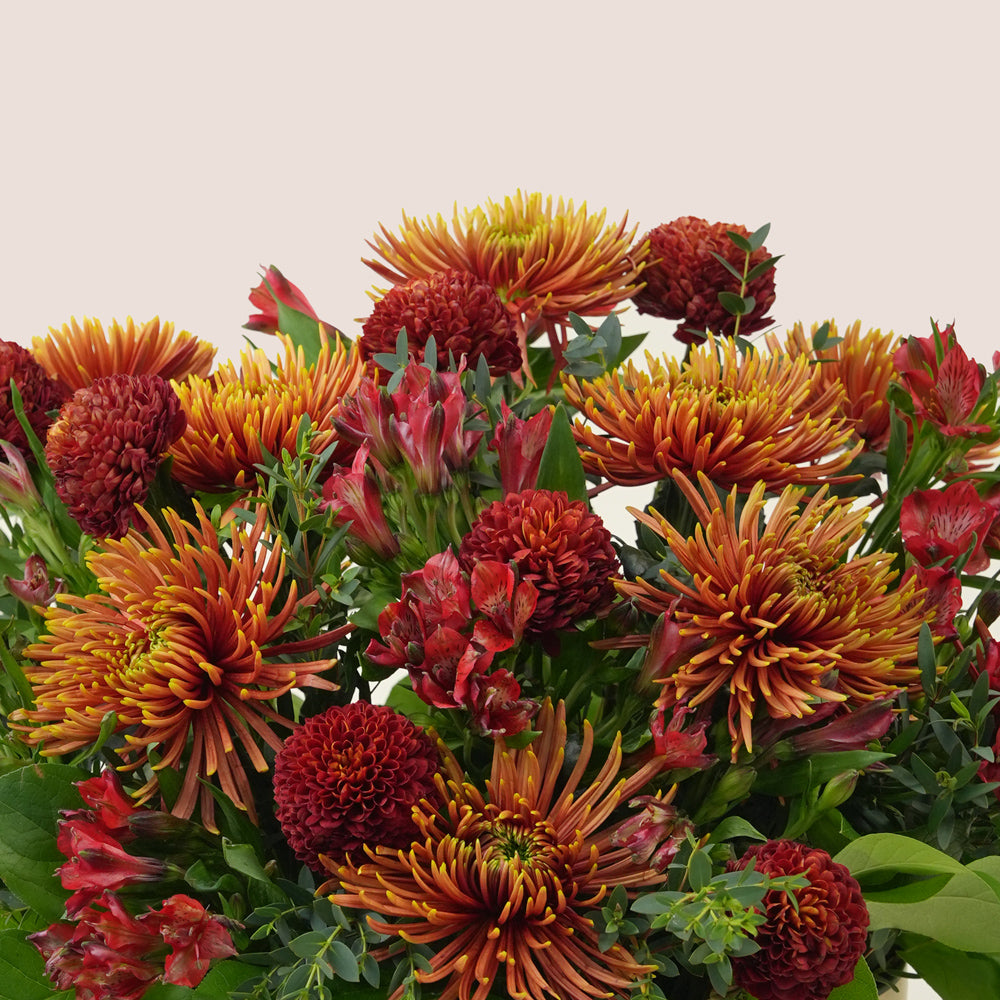 Ruby Eid flower arrangement in grande round box with premium truffles and petite fours gift box Dubai