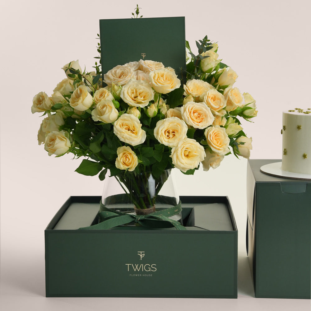 Eid flower vase arrangement with creamy roses in TWIGS carry box paired with celebration cake gift set Dubai