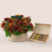 Ruby Eid flower arrangement in grande round box with premium truffles and petite fours gift box Dubai