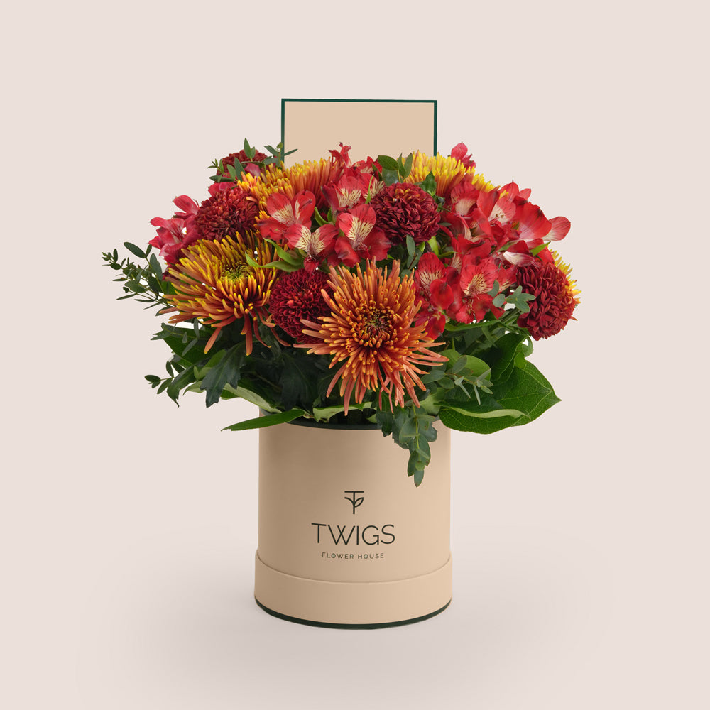 Eid flower arrangement with saffina chrysanthemums and burgundy ping pong chrysanthemums paired with Rituals Sweet Jasmine gift set in TWIGS deluxe round box Dubai