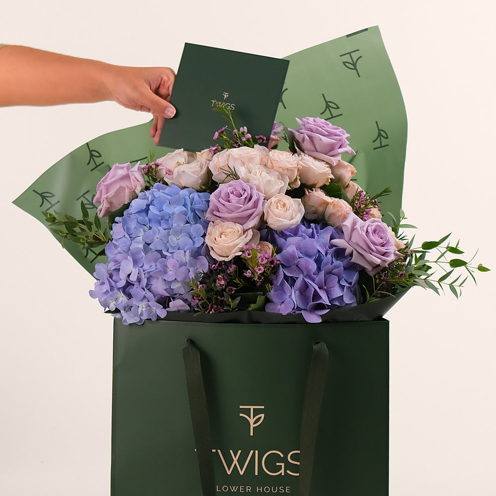 Purple Hydrangea & Rose Hand Bouquet – Soft Elegance in a Chic Flower Gift Bag