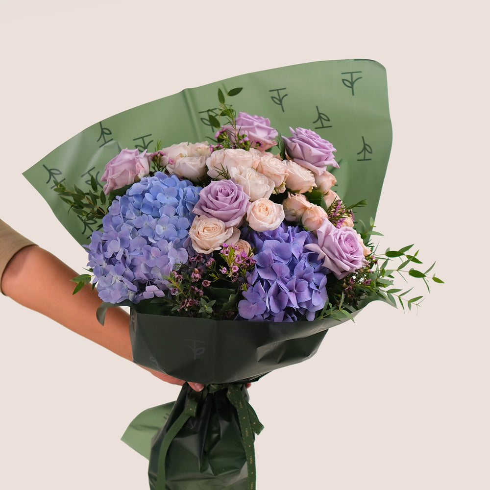 Purple Hydrangea & Rose Hand Bouquet – Soft Elegance in a Chic Flower Gift Bag