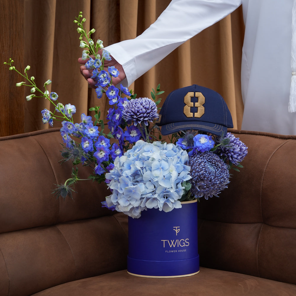 Blue Dusk & Code Eight — blue hydrangeas, delphiniums and chrysanthemums in a TWIGS navy round box with Code 8 baseball cap, Father's Day gift set Abu Dhabi