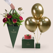 A beautiful festive flower bunch featuring a vibrant red Christmas flower arrangement With red peonies placed beside a decorated cake