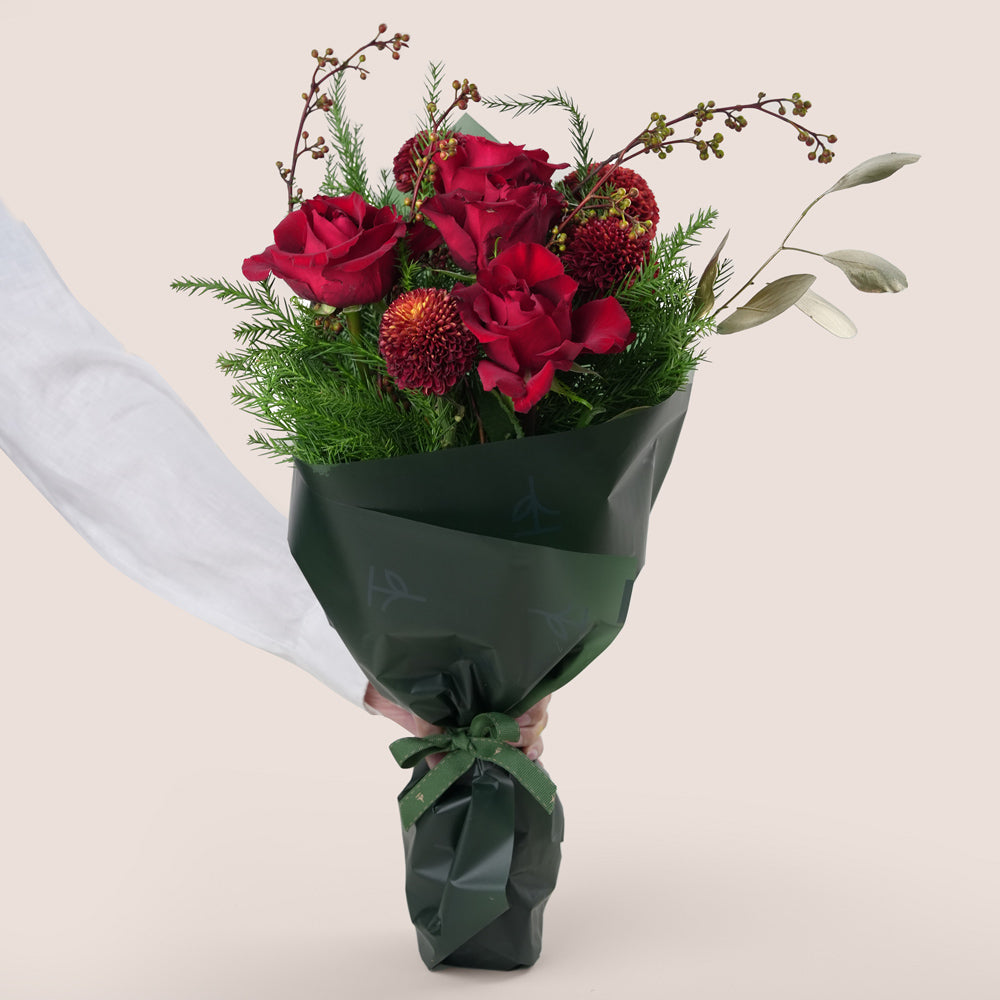 Christmas bouquet with red roses and pine leaves Twigs UAE