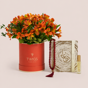 Orange Alstroemeria in a TWIGS box beside a Light of Sakina Aqeeq misbaha and Baraka perfume oil, TWIGS x Light of Sakina collaboration