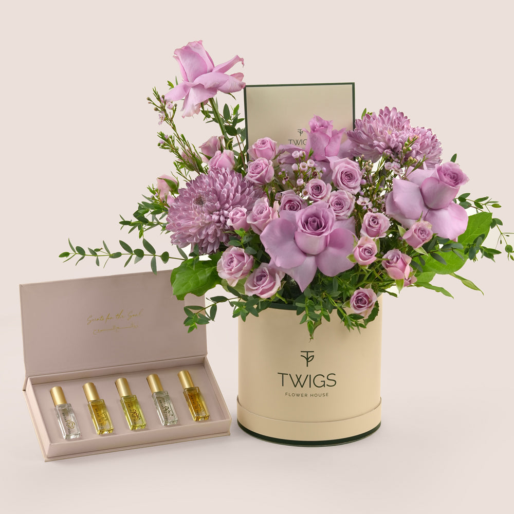 Emirati Women's Day lavender roses and purple chrysanthemums Deluxe round box bundled with Massarah Light of Sakina perfume oil discovery set