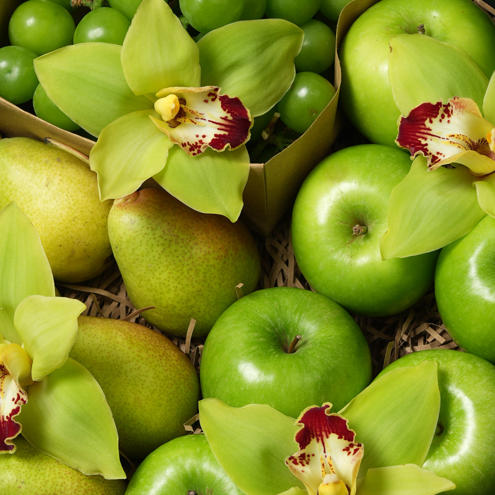 TWIGS Green Box with fresh Granny Smith apples, green pears, green grapes and yellow cymbidium orchids in a dark green gift box, Dubai UAE