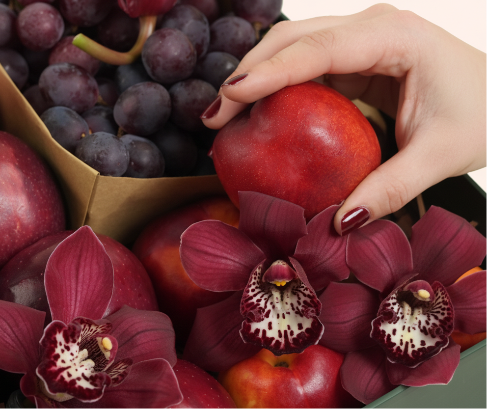 TWIGS Red Box with fresh red apples, nectarines, dark grapes and burgundy cymbidium orchids in a dark green gift box, Dubai UAE