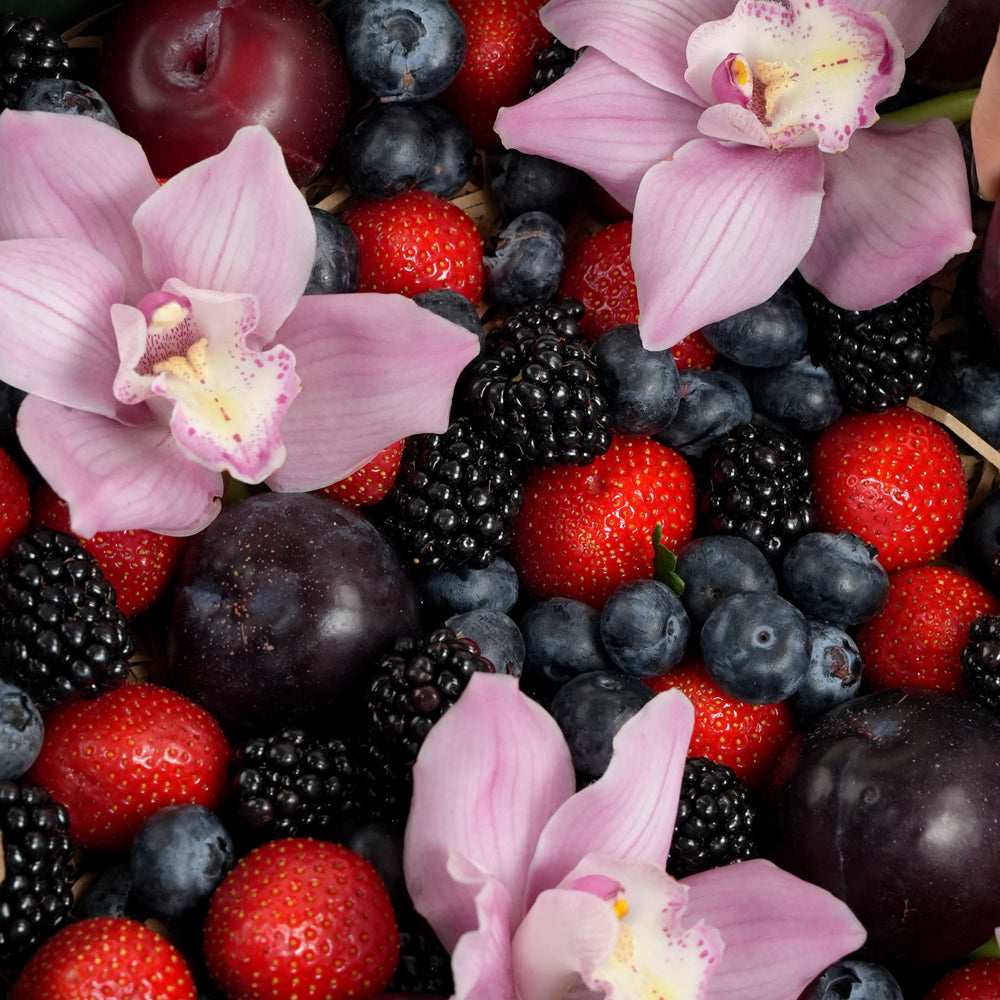 TWIGS Berry Box with fresh strawberries, blackberries, blueberries, dark plums and pink orchids in a dark green gift box, Dubai UAE