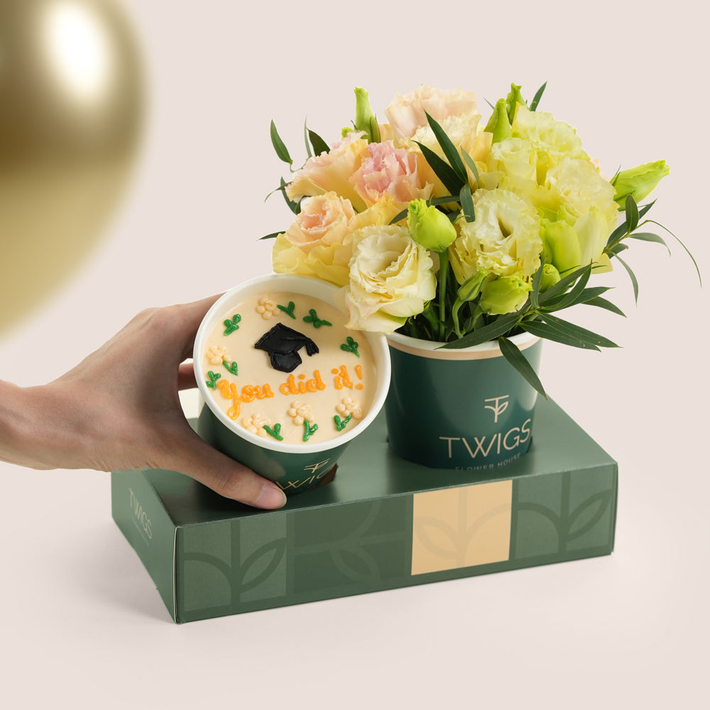 Graduation combo with white flowers in TWIGS cup, chocolate cupcake with "You did it!" topper, and three gold chrome balloons — TWIGS UAE