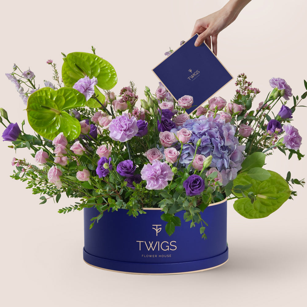 Purple hydrangea and green anthurium grande round flowers in blue box by TWIGS