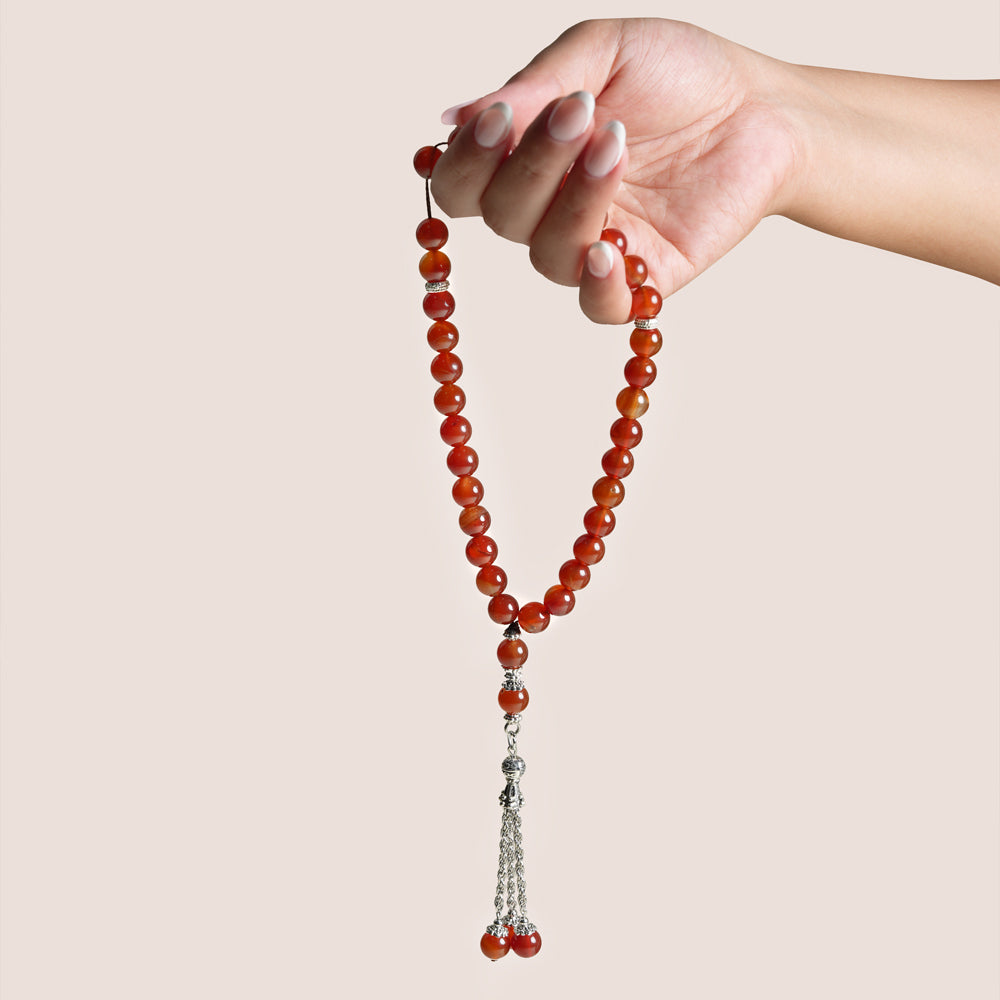 Red Aqeeq misbaha prayer beads with silver accents in an open beige keepsake box, TWIGS x Light of Sakina collaboration