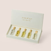 Five Massarah perfume oil bottles in an open beige box beside a gold scent guide card, TWIGS x Light of Sakina collaboration