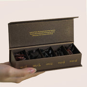 Five Tuba bakhoor compartments labeled Hala, Mizla, Afna, Talia, Inara in open brown box, TWIGS x Light of Sakina collaboration