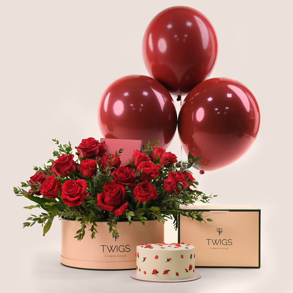 Luxury red rose garden box in Dubai with premium red roses  with cake and red balloons by TWIGS Flower House