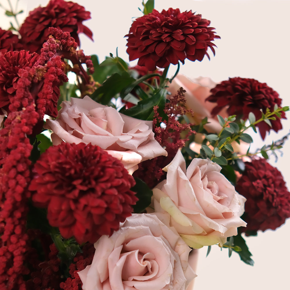 Manar’s Choice – Burgundy Deco Mums & Quicksand Roses in Coral Ceramic Vase