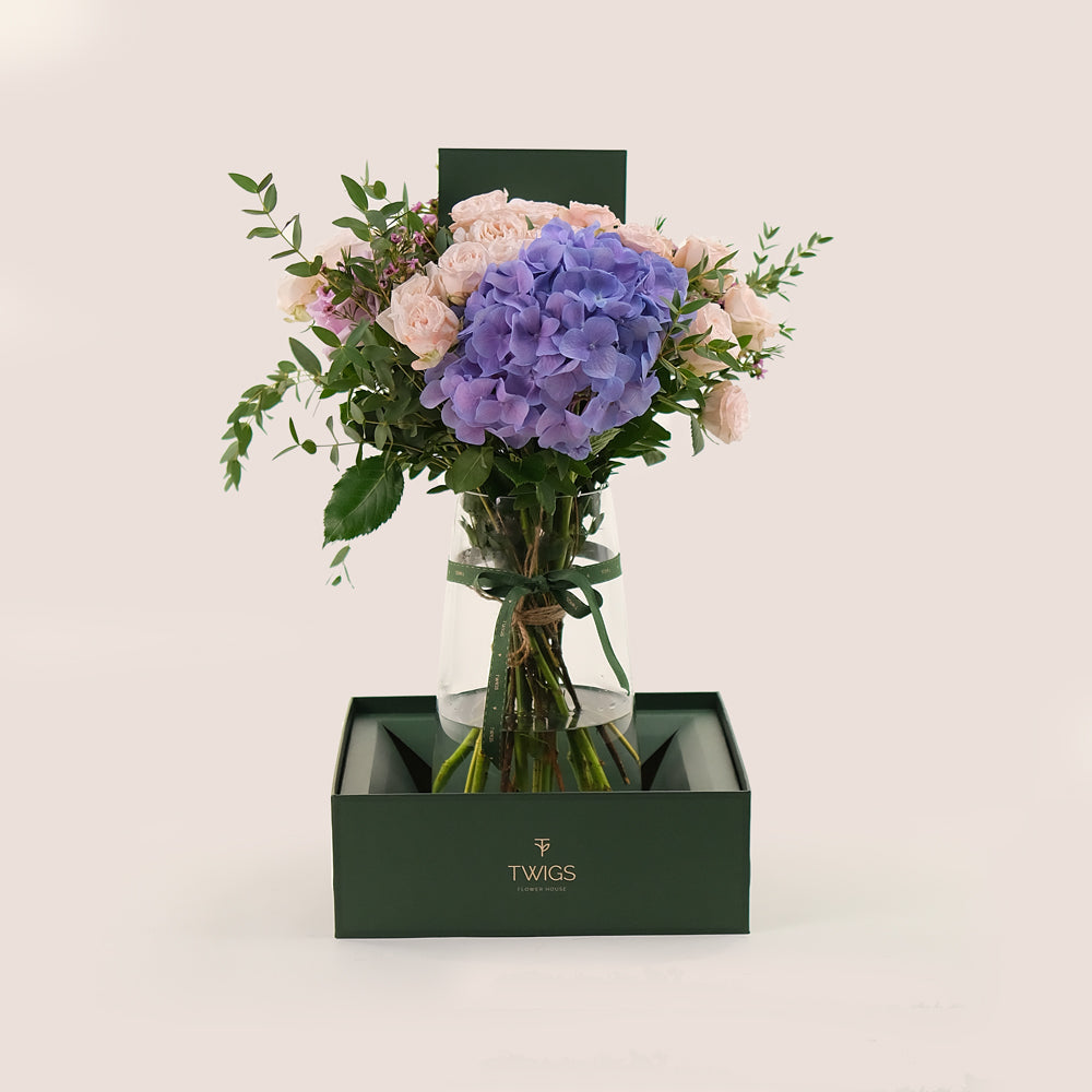 Lavender Elegance in a Flower Vase – A Refined Mix of Purple Hydrangea, Roses, and Wax Flowers