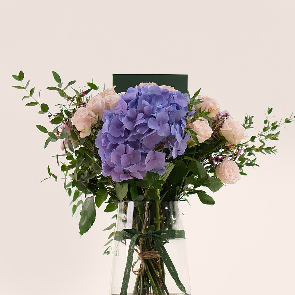 Lavender Elegance in a Flower Vase – A Refined Mix of Purple Hydrangea, Roses, and Wax Flowers