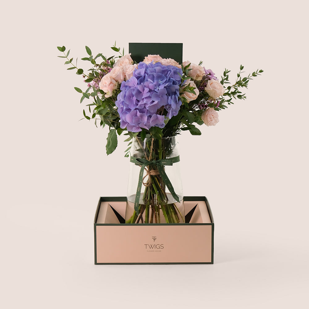 Lavender Elegance in a Flower Vase – A Refined Mix of Purple Hydrangea, Roses, and Wax Flowers