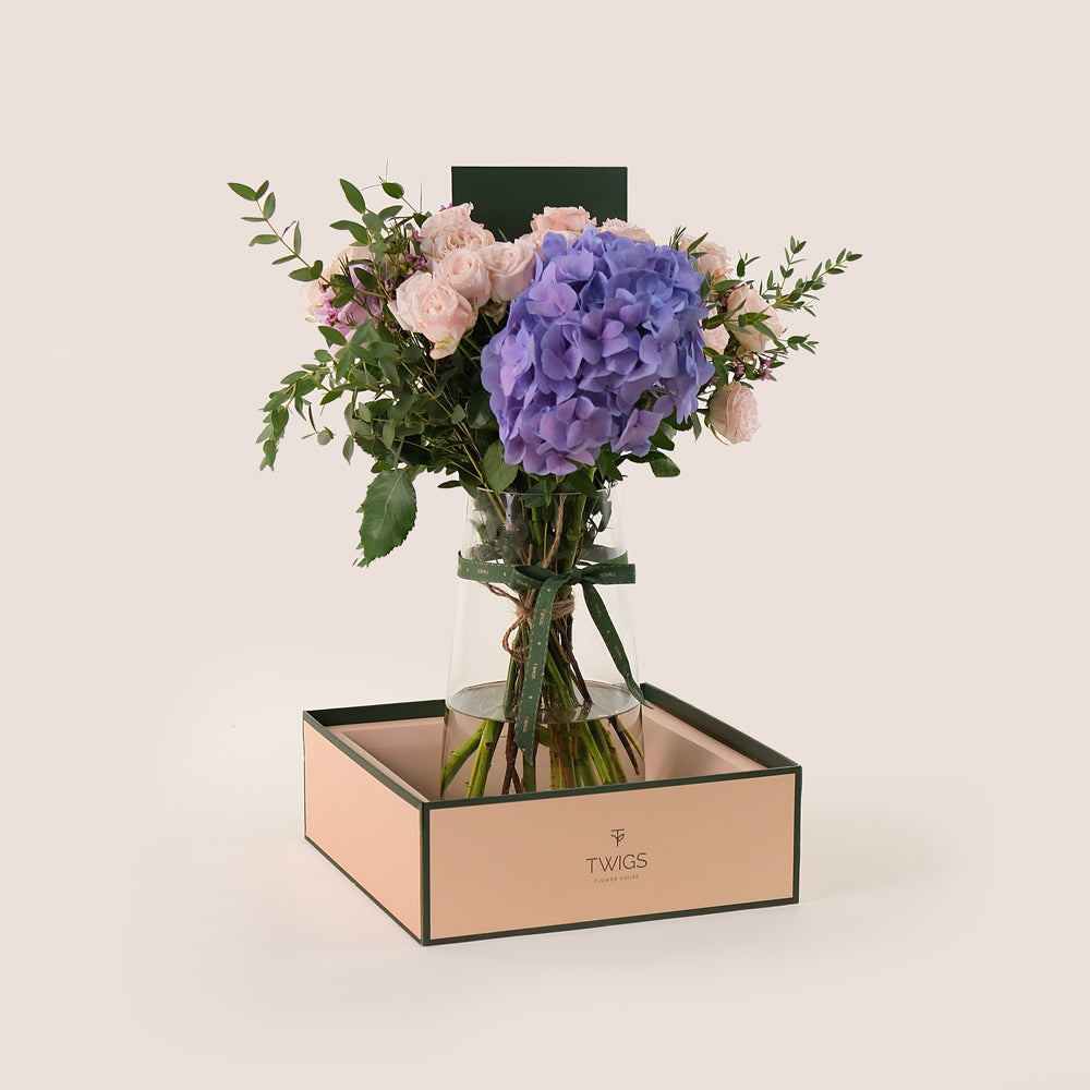 Lavender Elegance in a Flower Vase – A Refined Mix of Purple Hydrangea, Roses, and Wax Flowers